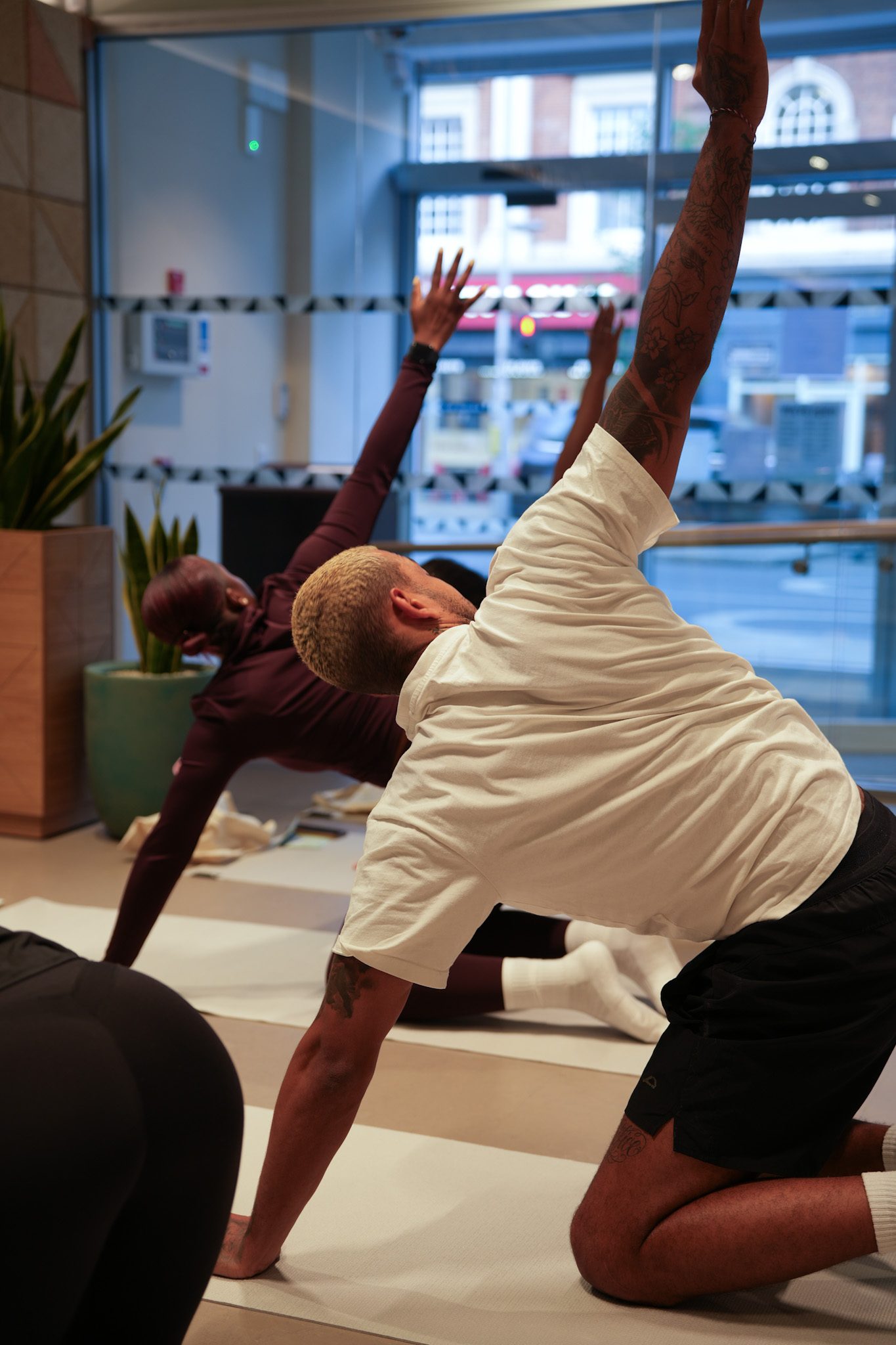 Group stretching session in a light-filled Heaven's Touch studio
